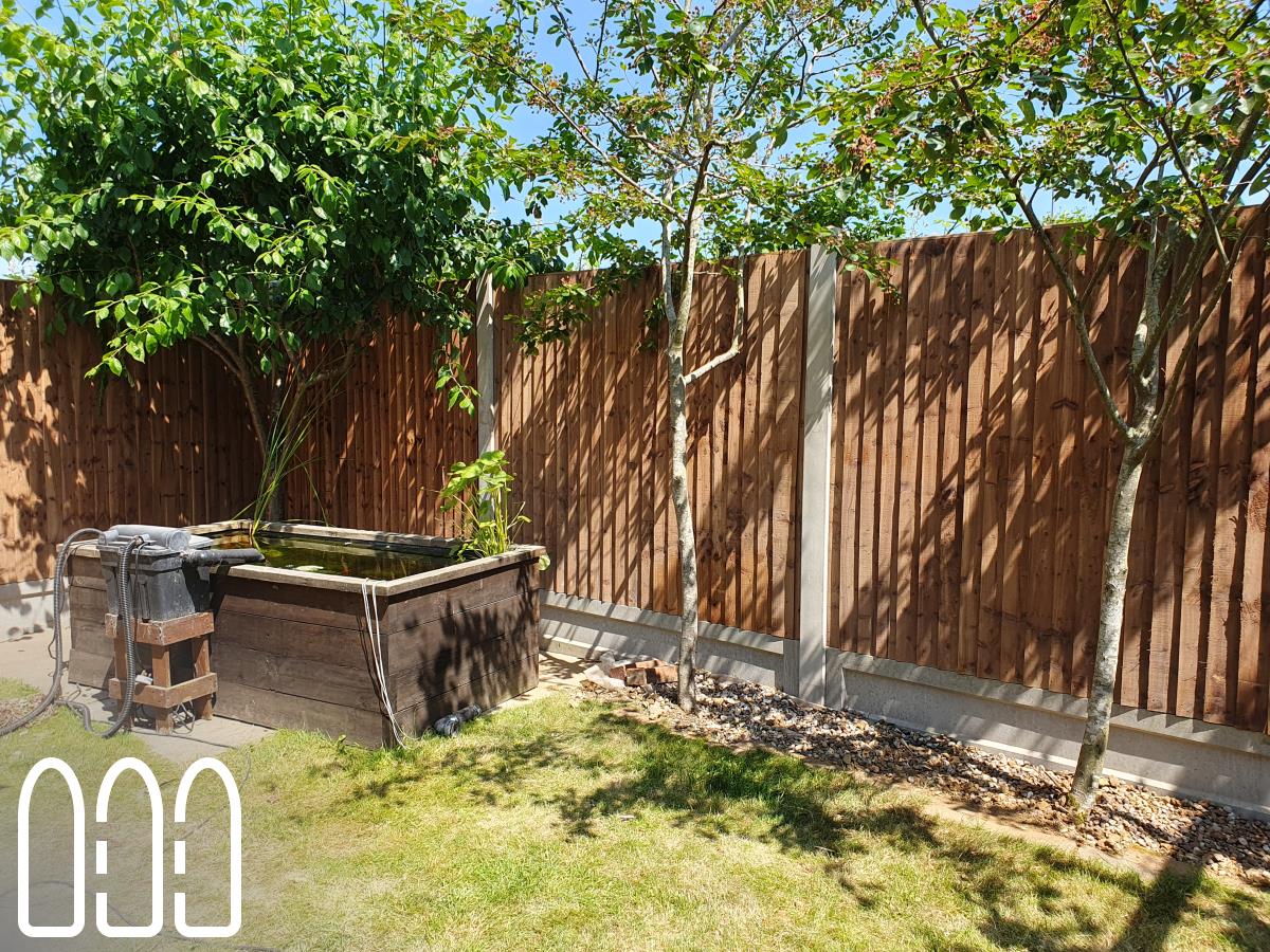 Installation of a new fence built from concrete posts, concrete gravel boards and close board feather edge fence panels.