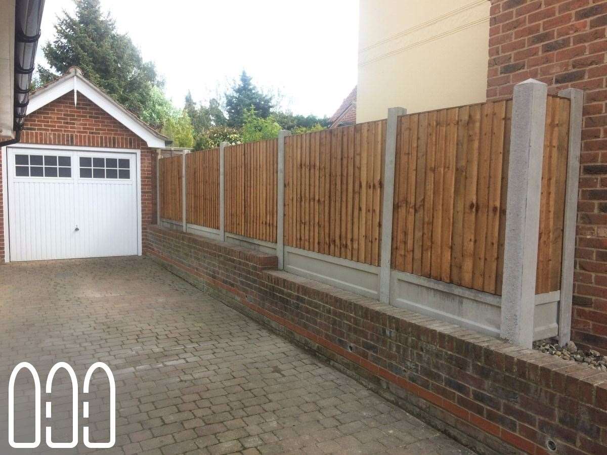 Close board fencing with concrete posts and gravel boards