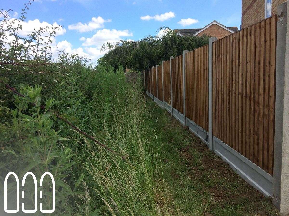 Close board fencing with concrete posts and gravel boards