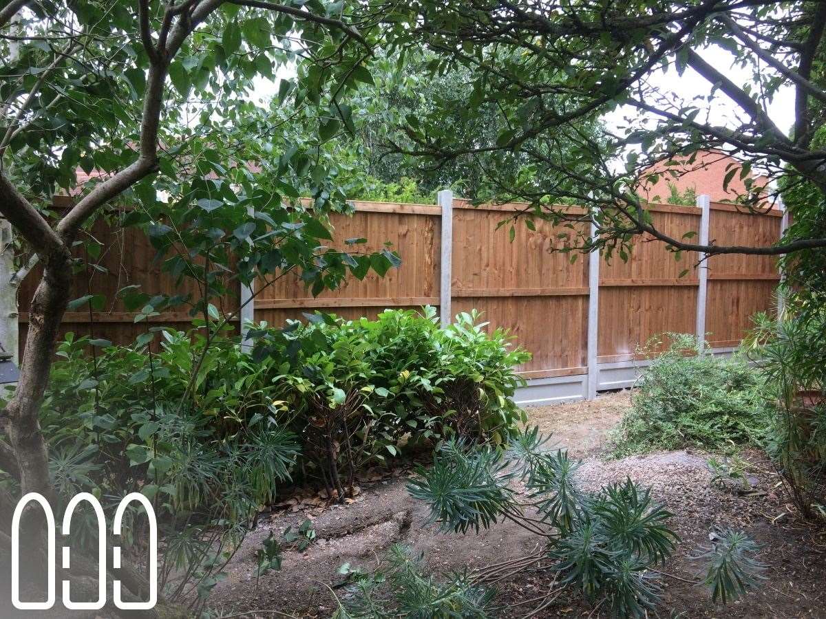 Close board fencing with concrete posts and gravel boards