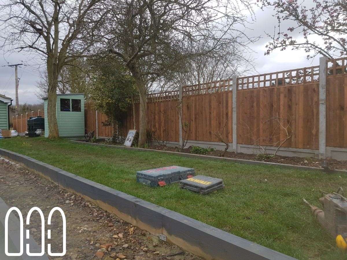 Close board fencing with concrete posts, gravel boards and a box trellis