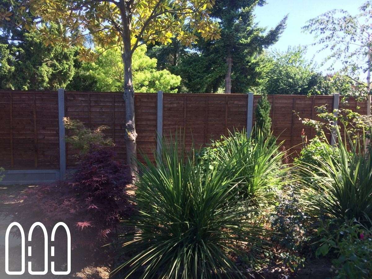 Waney fencing with concrete posts and gravel boards