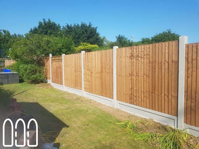 Close board fencing with concrete posts, gravel boards and a box trellis