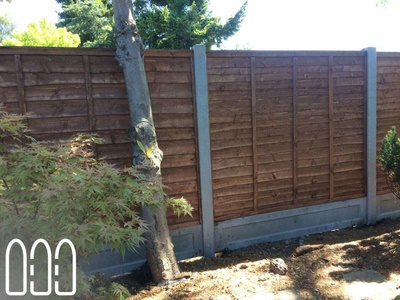 Waney fencing with concrete posts and gravel boards